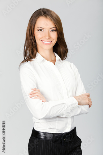 Smiling businesswoman, over gray