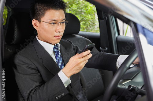 Texting on cell phone while driving © Arto