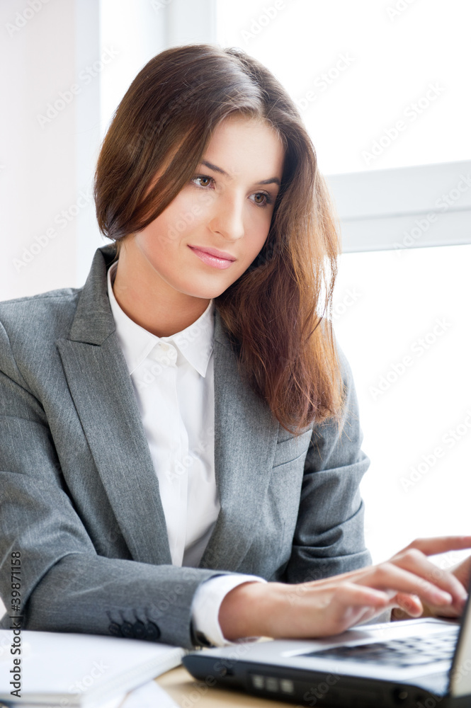 Business woman working on computer at her office Business woman working on computer at her office
