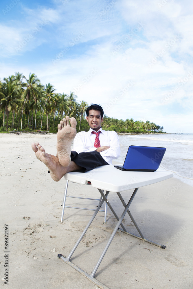 Businessman relaxing at beach