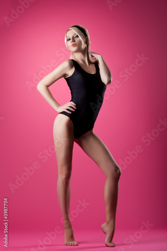 Fototapeta Naklejka Na Ścianę i Meble -  Beauty woman sport pin-up style stand on pink