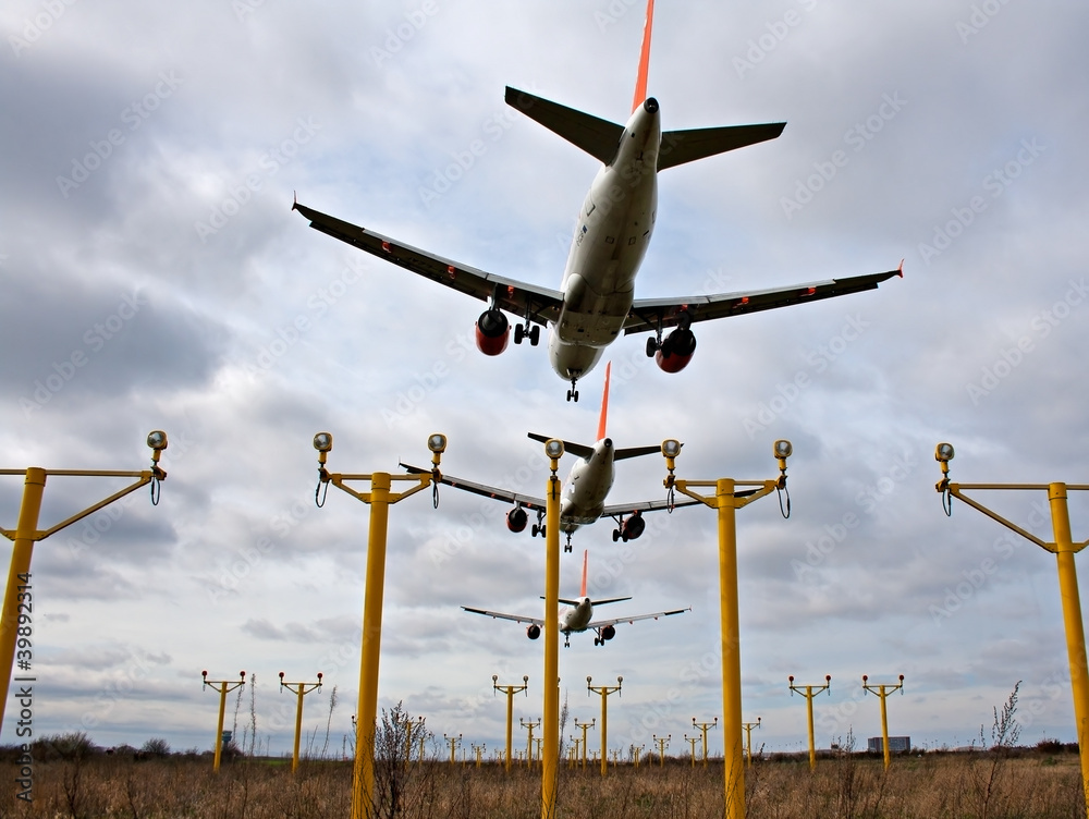 Composite of 3 airplanes landing close together Composite of 3 airplanes landing close together