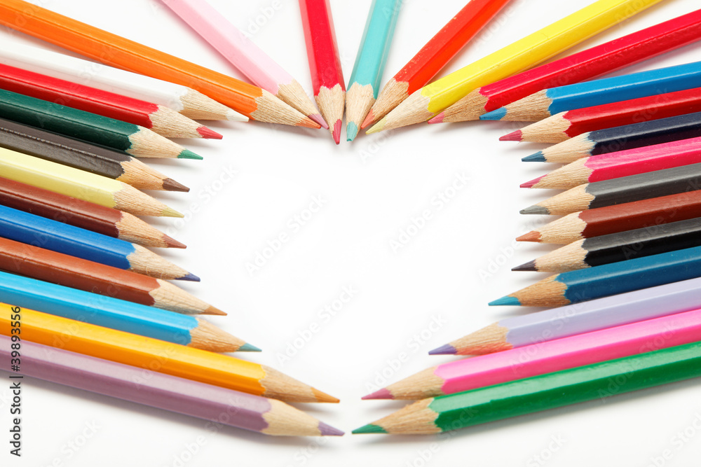 Fototapeta premium colored pencils crayons composed in the form of heart