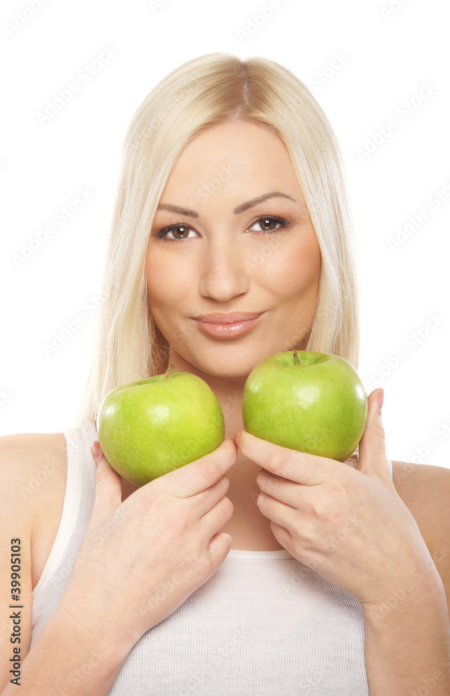 A young blond woman holding fresh green apples A young blond woman holding fresh green apples