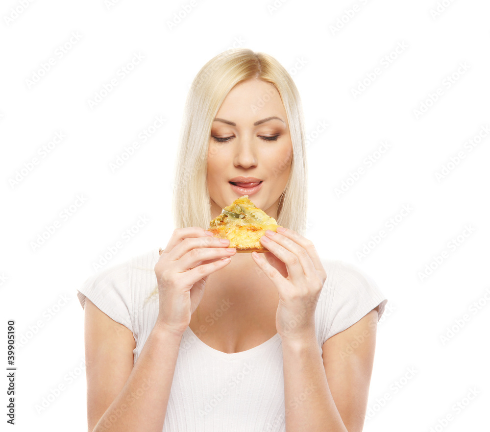 A young blond woman eating a pizza slice A young blond woman eating a pizza slice