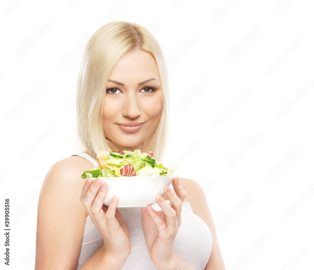A young blond woman holding a fresh green salad A young blond woman holding a fresh green salad