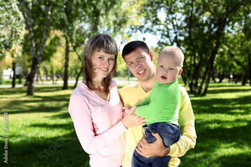 Young family with a child in summer park © Sergey Nivens