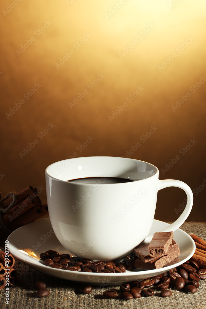 Obraz premium cup of coffee and beans, cinnamon sticks and chocolate