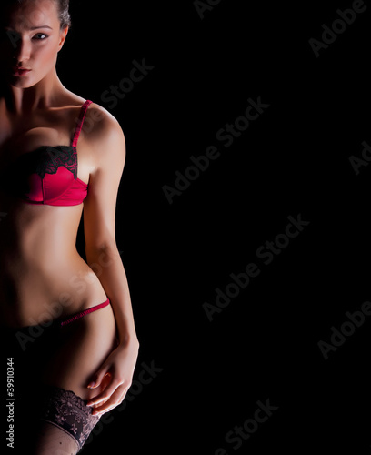 Fashion shoot of a young woman in erotic lingerie