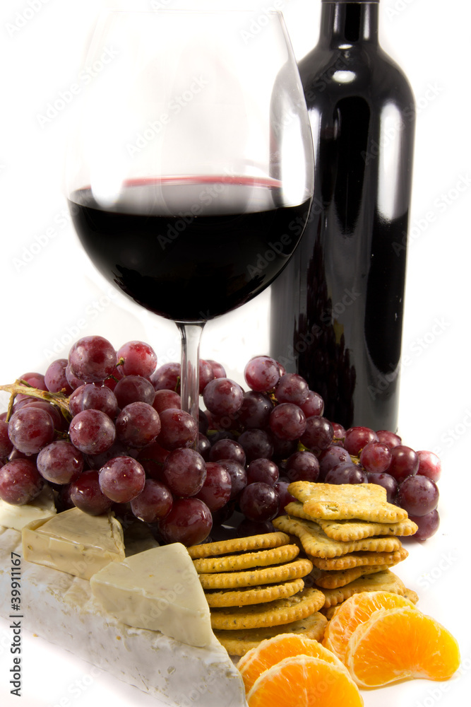 Bottle of red wine with some grapes