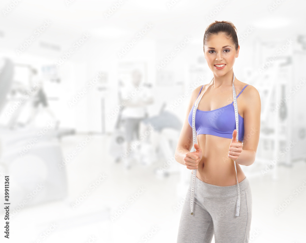 A young and fit Caucasian woman in sporty clothes