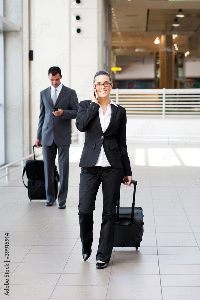 businesspeople walking in airport with luggage businesspeople walking in airport with luggage