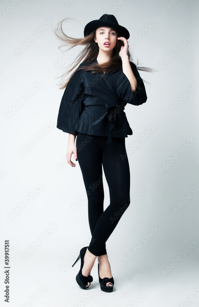 Fashionable brunette hair girl in a black hat. Retro style Fashionable brunette hair girl in a black hat. Retro style