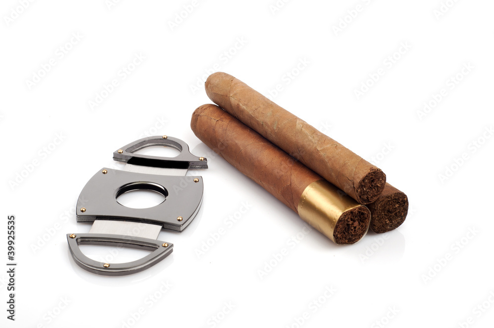 Cigars and a open cutter isolated on white background