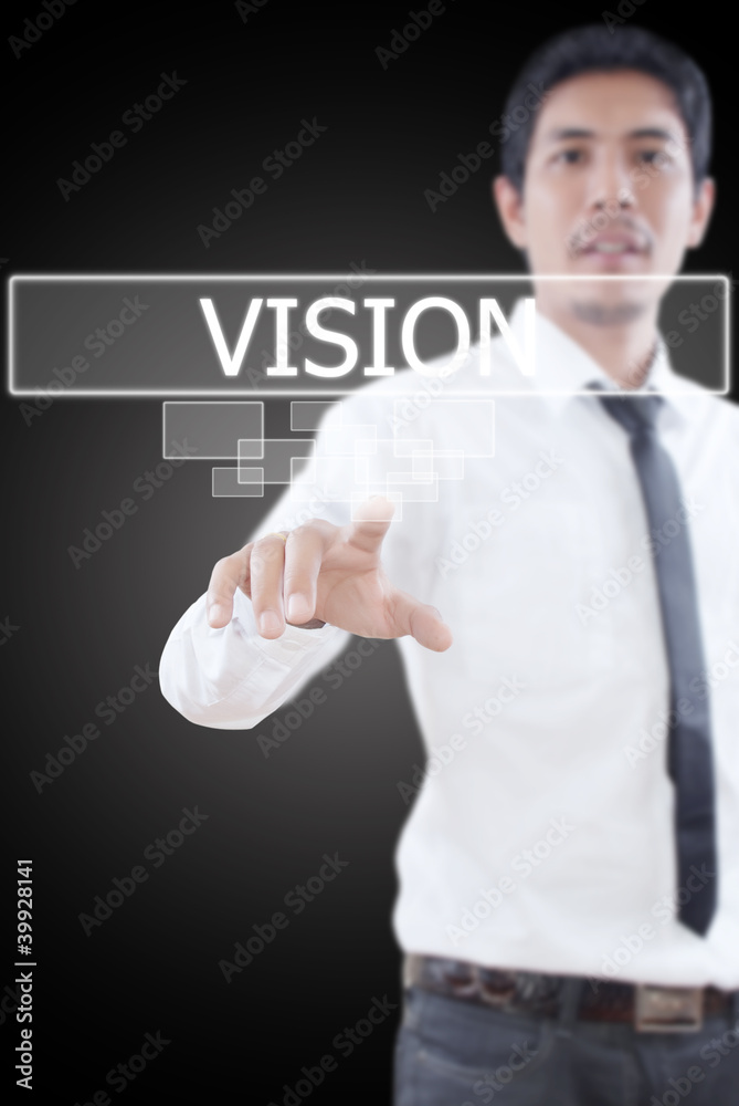Businessman pushing Vision word on a touch screen interface. Businessman pushing Vision word on a touch screen interface.