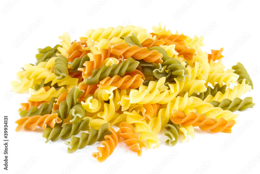 Uncooked pasta fusilli in different colours, white background Uncooked pasta fusilli in different colours, white background
