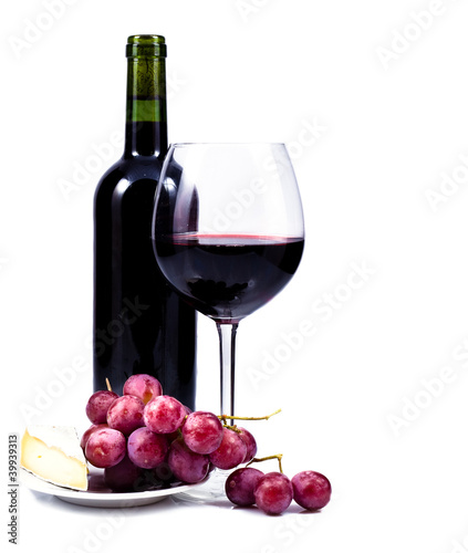 wine glass with red wine, bottle of wine and grapes