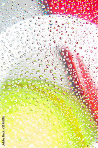 Water droplets on glass with background yellow and red colors photo