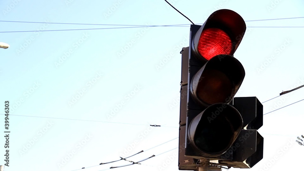 Town traffic light on background sky