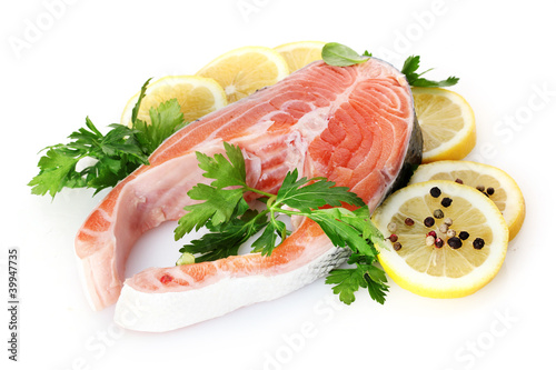Red fish with lemon, parsley and pepper isolated on white.