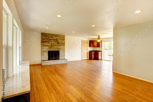 White new large living room with fireplace.