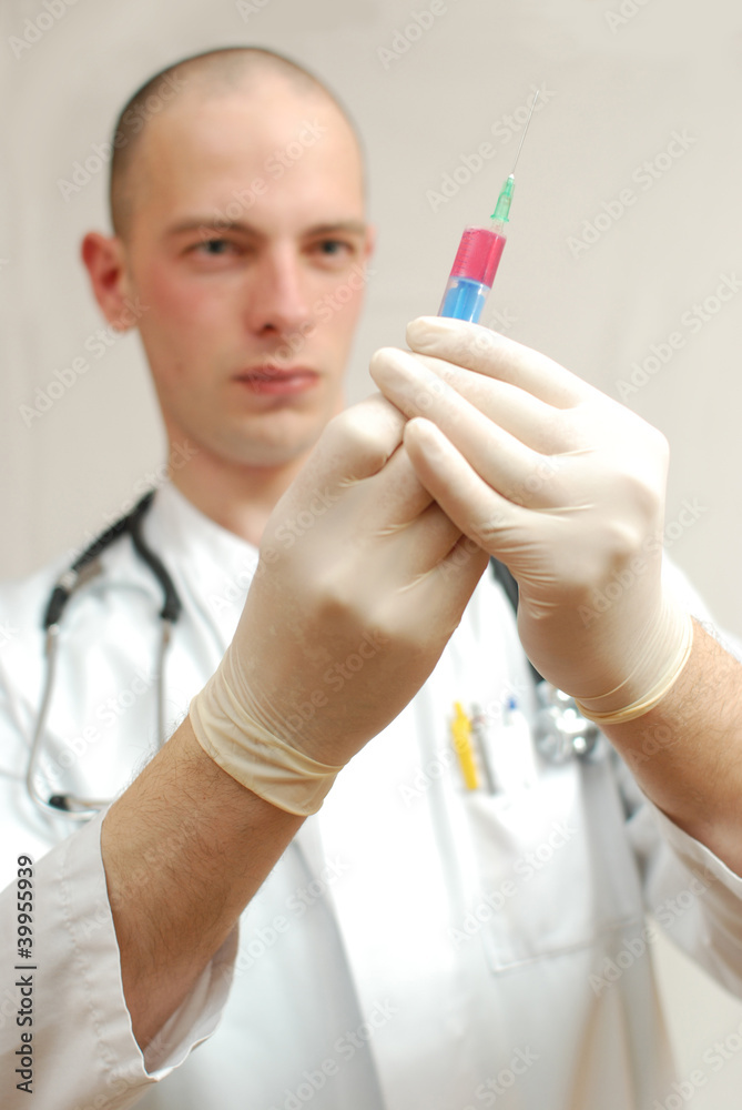 young male doctor holding vaccine in his hand young male doctor holding vaccine in his hand