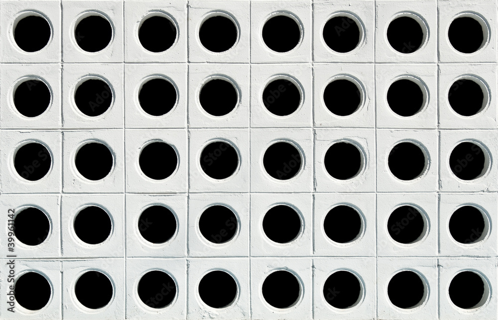 White wall with black holes