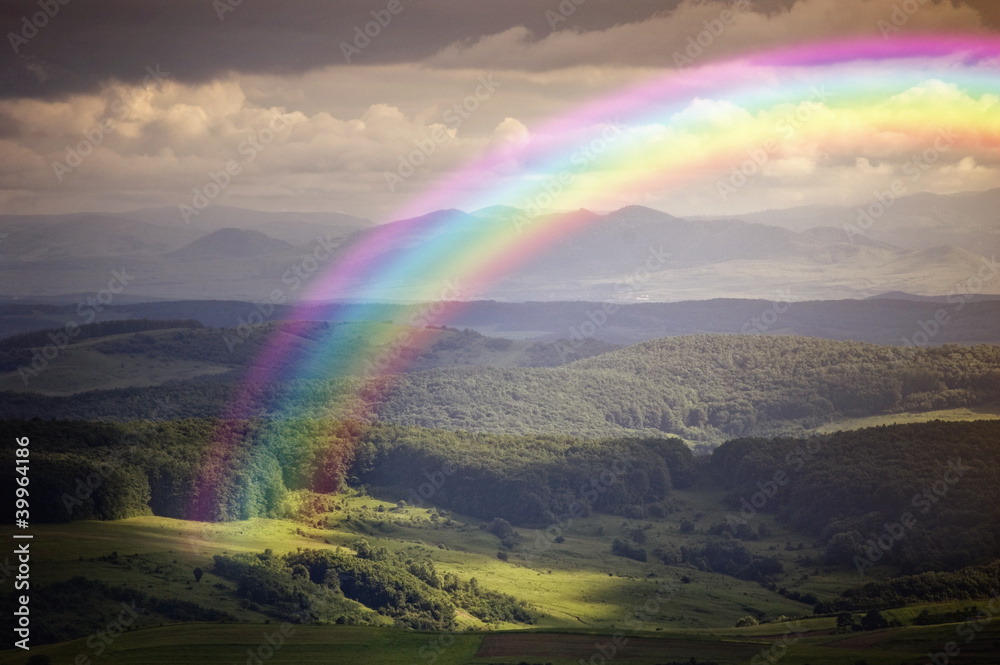 sunrise with rainbow on a summer day