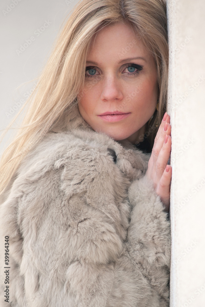 Close up portrait of young blond woman with fur. Close up portrait of young blond woman with fur.