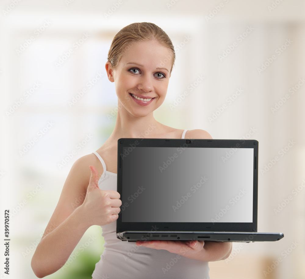 young woman showing laptop with empty space on the screen young woman showing laptop with empty space on the screen