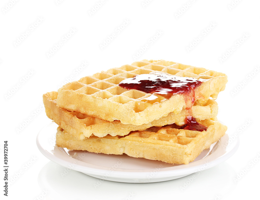Tasty waffles with jam on plate isolated on white Tasty waffles with jam on plate isolated on white