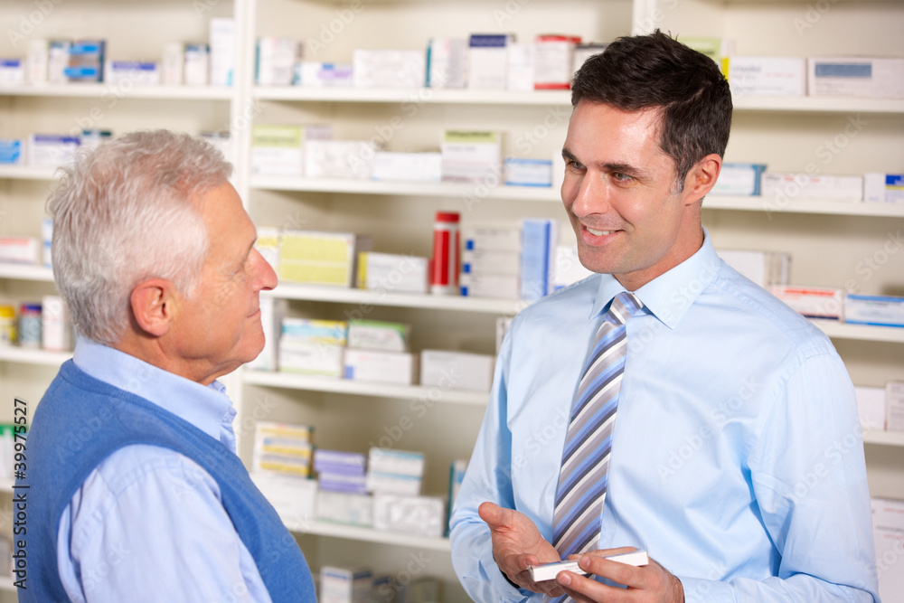 UK pharmacist serving  senior man in pharmacy