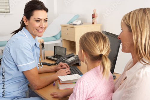 British nurse talking to young child and mother photo