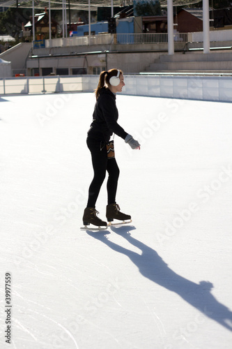 Slim Young Woman Ice Skating On An Ice Rink