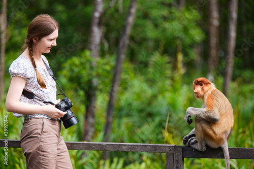 Canvas Print Female photographer and proboscis monkey
