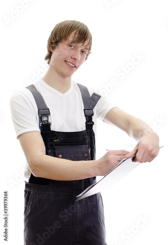 Young warehouse worker makes notes. Isolated on white