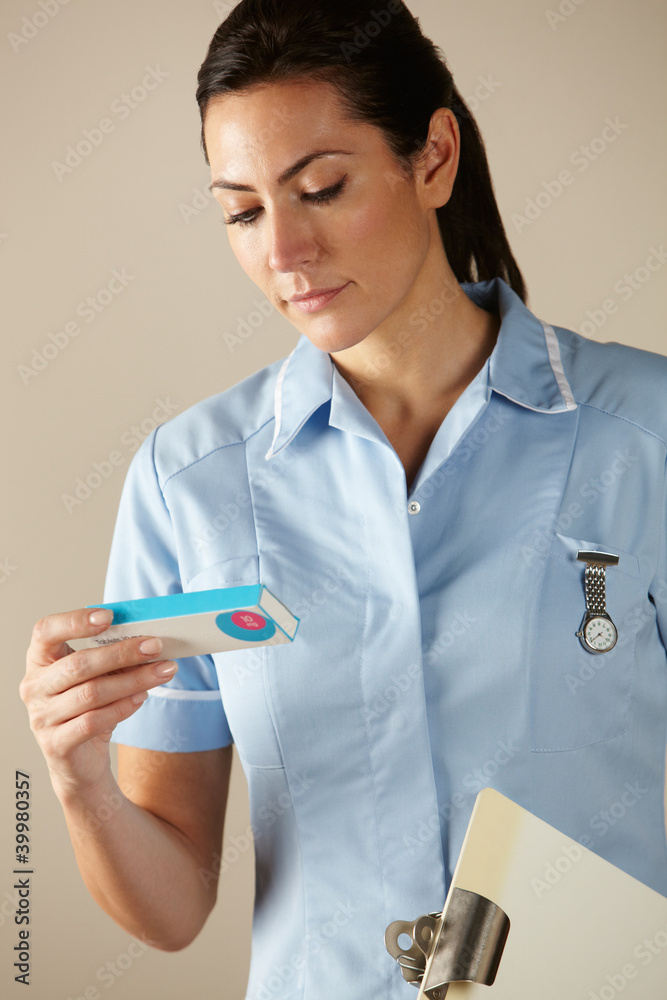 UK nurse holding prescription drug pack UK nurse holding prescription drug pack