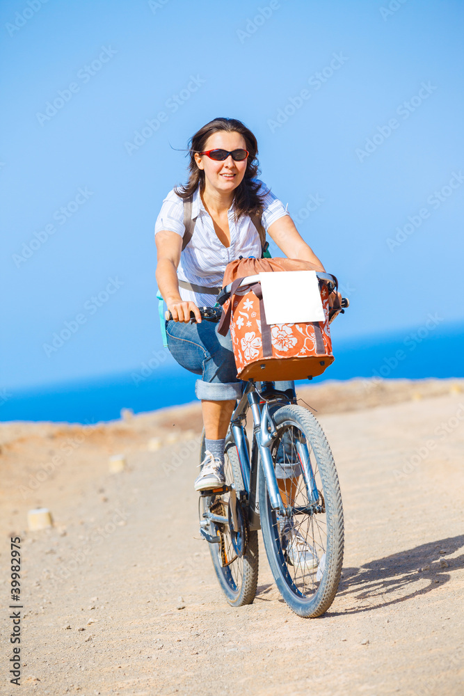 Fototapeta premium Woman on bike outdoors smiling