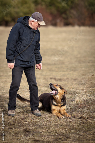 Master and his obedient (German Shepherd) dog