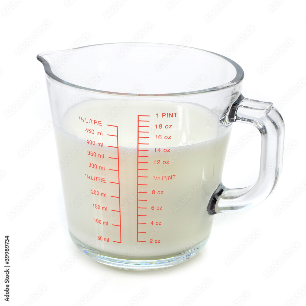 Milk in measuring cup Stock Photo | Adobe Stock