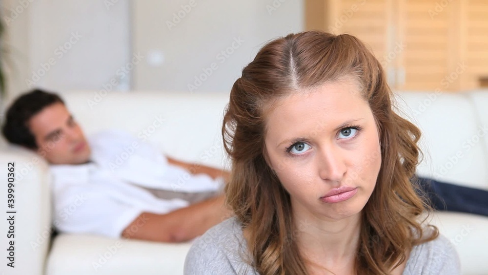 Bored woman with her sleeping boyfriend Bored woman with her sleeping boyfriend