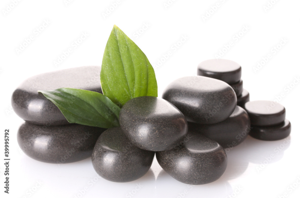 Spa stones and green leaves isolated on white Spa stones and green leaves isolated on white