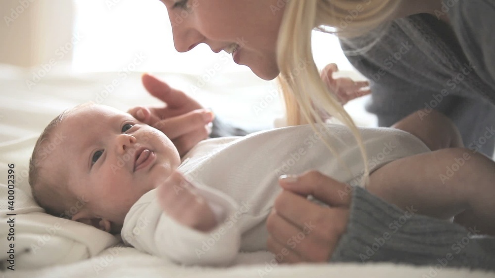 Woman holding and kissing a baby Woman holding and kissing a baby