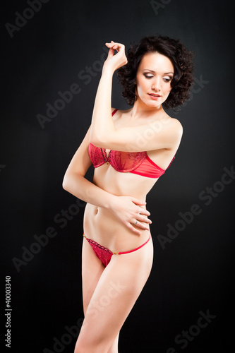 girl in red underwear on black background