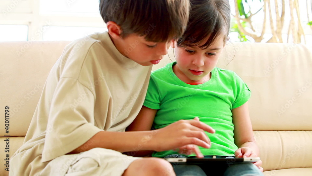 Children playing together with a tablet computer Children playing together with a tablet computer