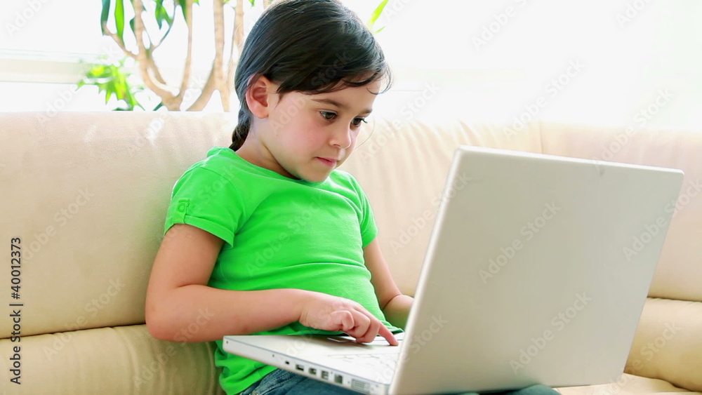 Cute little girl using a laptop