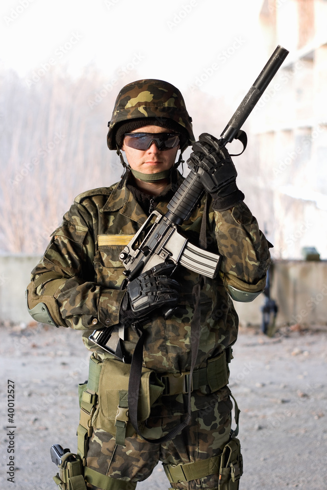Fototapeta premium Handsome guy holding a rifle