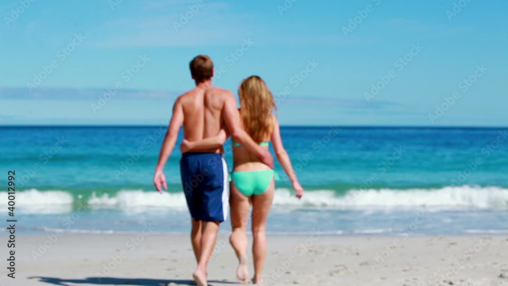 Happy couple walking while embracing Happy couple walking while embracing