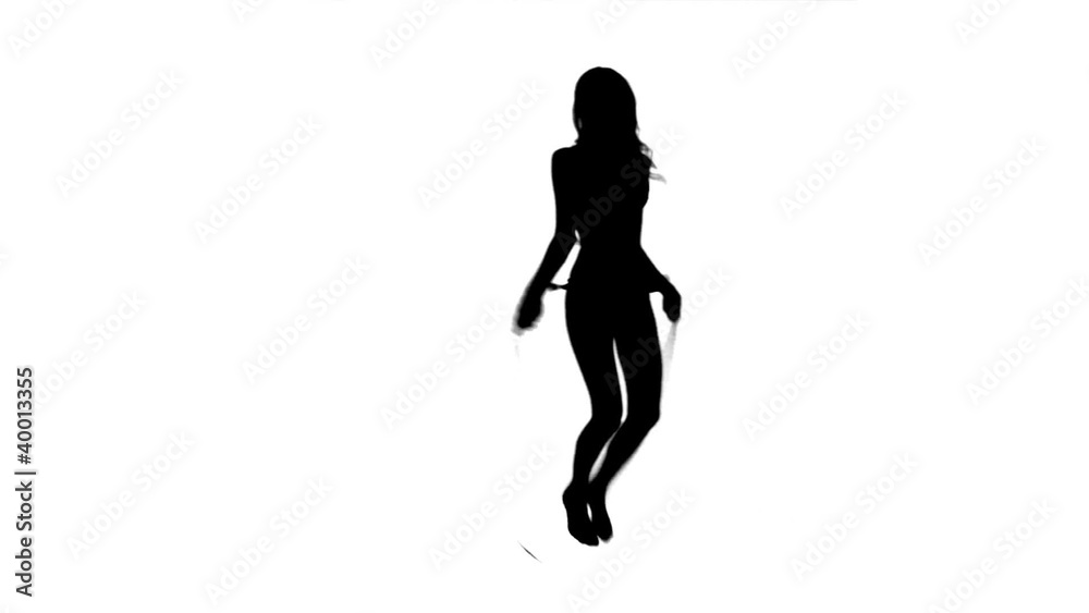 Silhouette of a woman using a skipping rope Silhouette of a woman using a skipping rope
