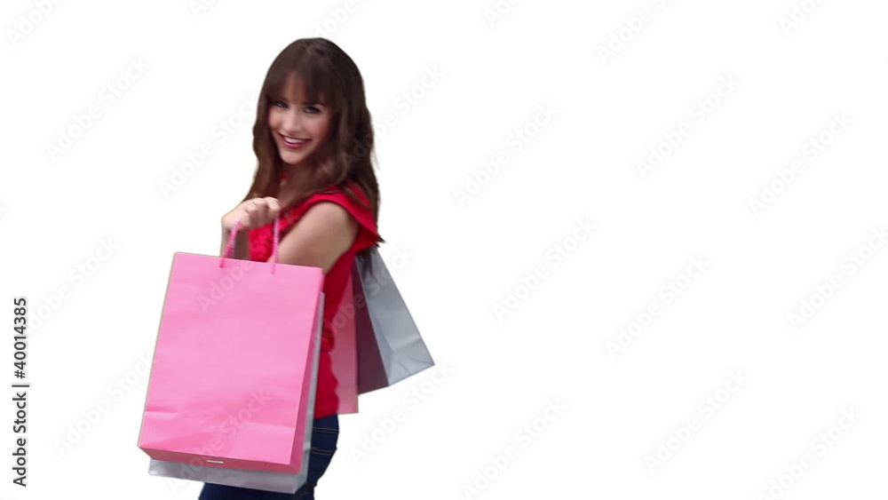 Woman walking across the screen while holding shopping bags Woman walking across the screen while holding shopping bags